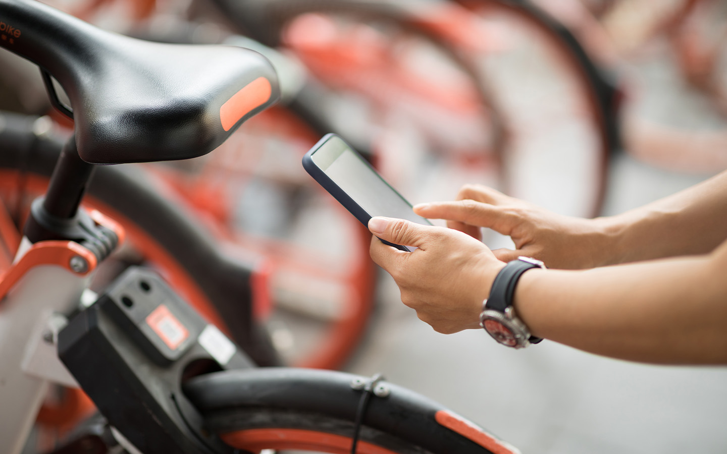 A rider unlocking a Hellobike bicycle with a smartphone app